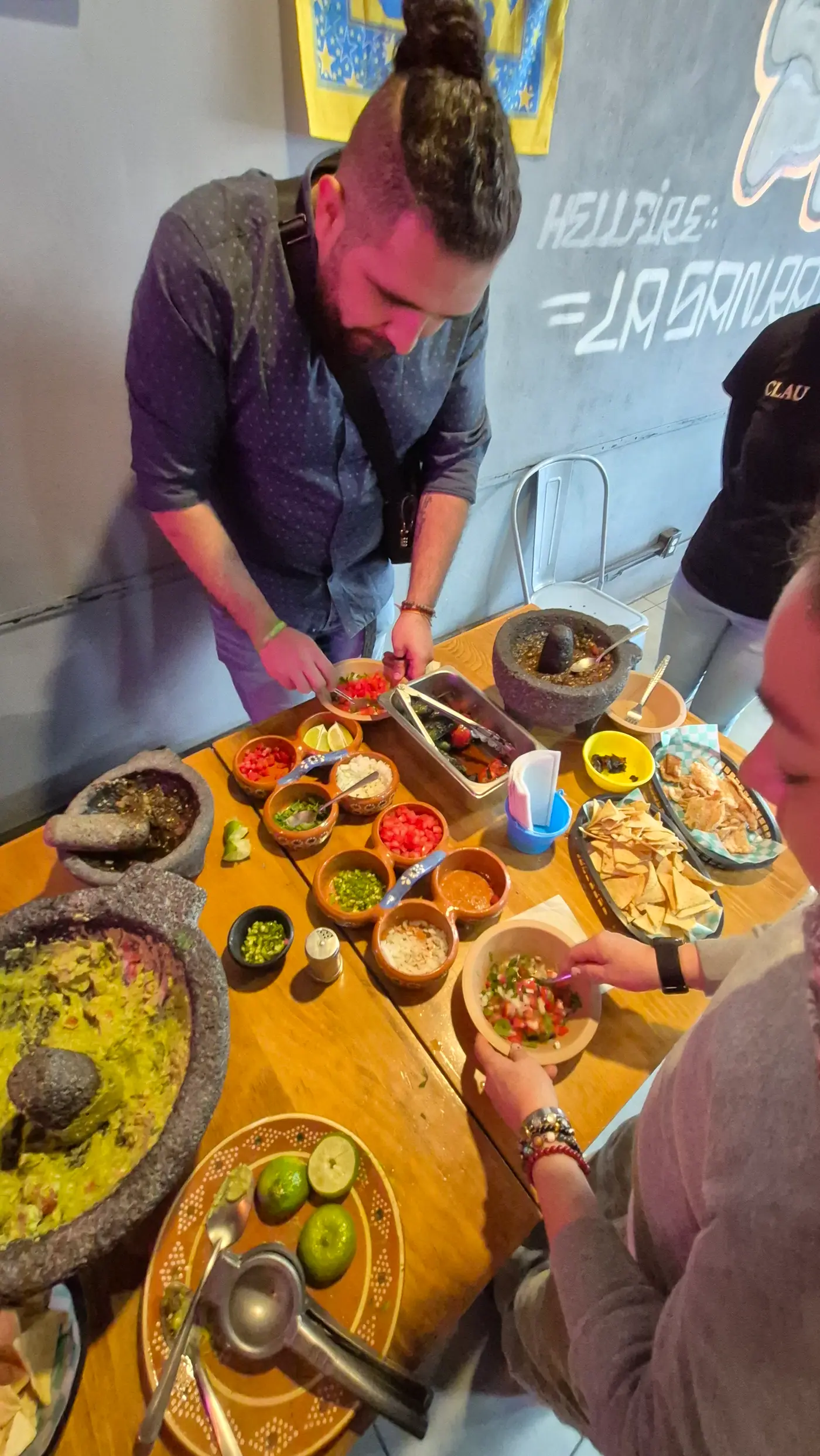Cooking class guests sharing food and micheladas at The Taco Experience